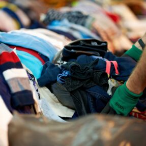 Used textiles being sorted in a distribution centre for charity shops, community groups, churches and local councils